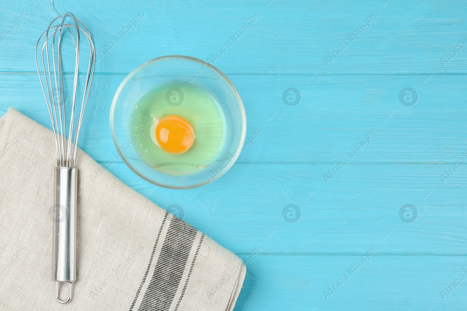 Photo of Flat lay composition with raw egg on light blue wooden table, space for text. Baking pie