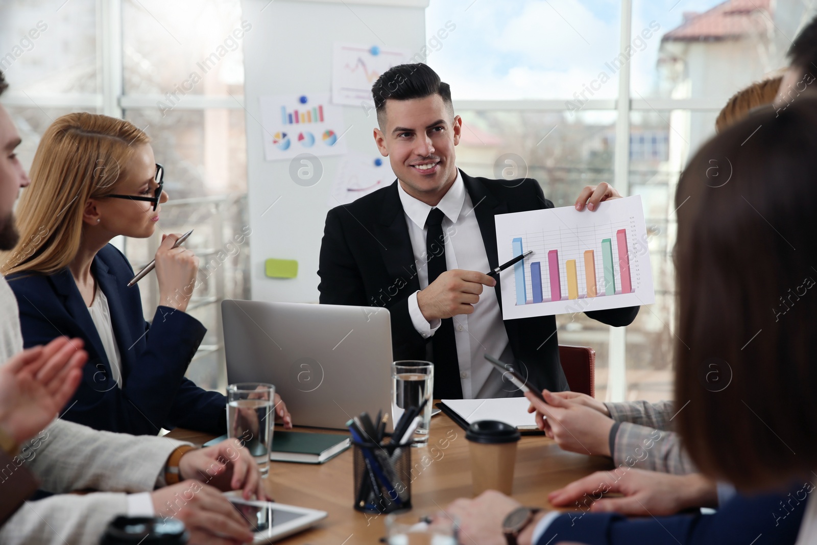 Photo of Businesspeople having meeting in office. Management consulting