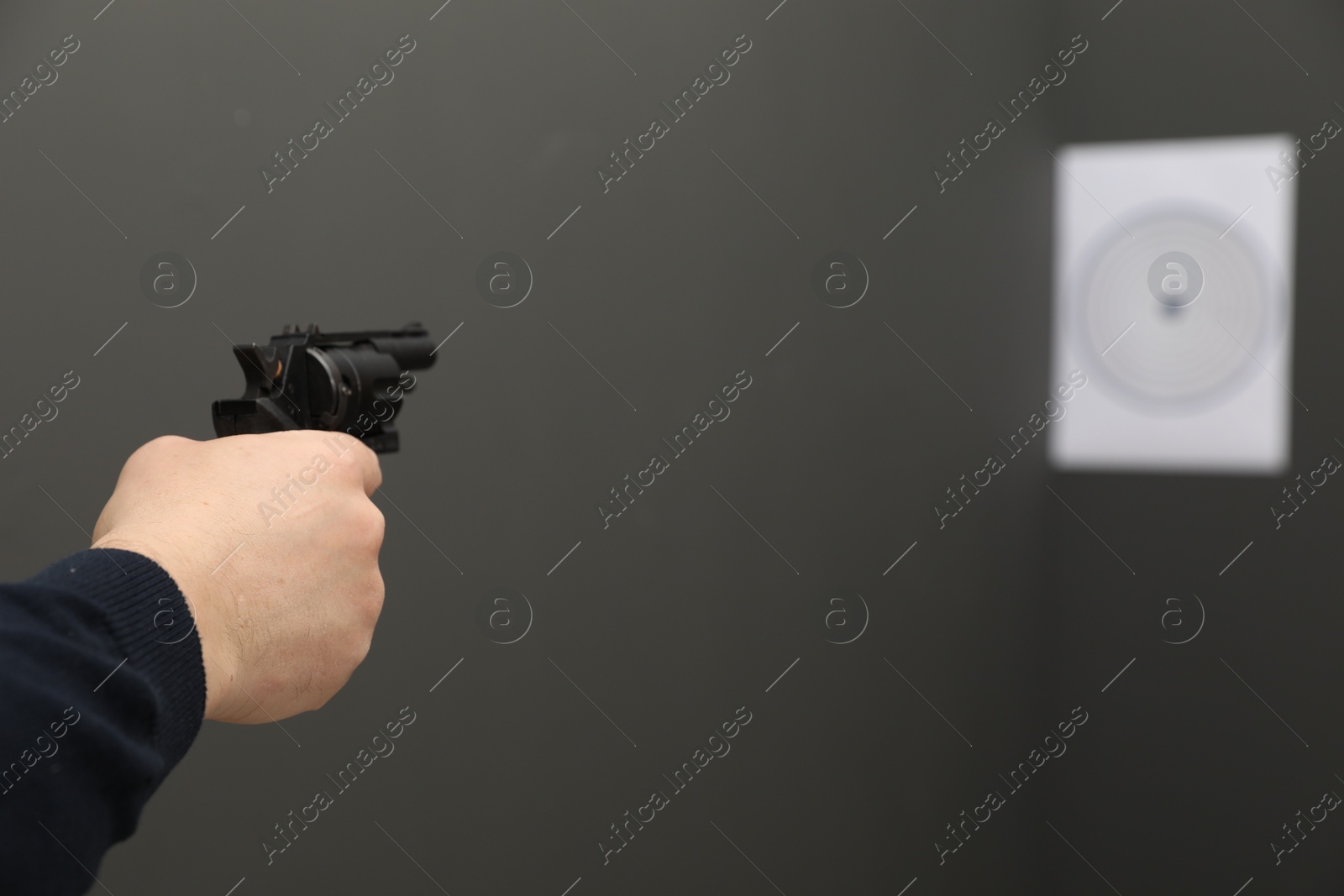 Photo of Man aiming at shooting target indoors, closeup. Space for text