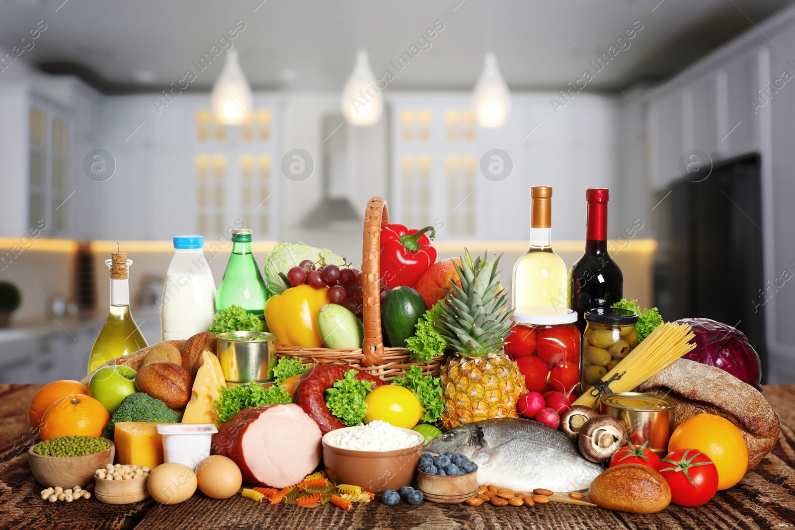 Image of Different products on wooden table in kitchen. Healthy food and balanced diet