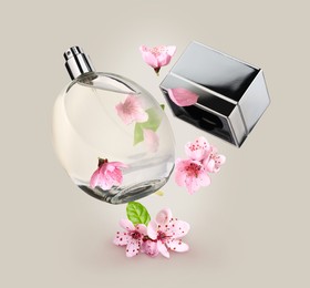 Image of Bottle of perfume and sakura flowers in air on greyish beige background