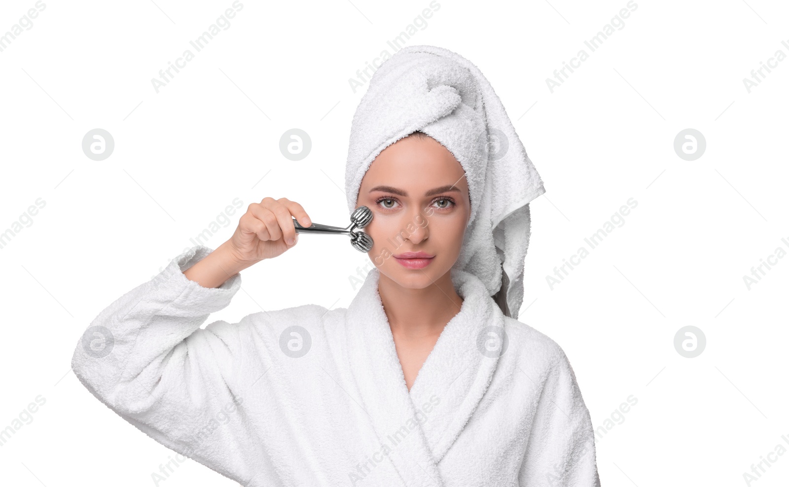 Photo of Young woman massaging her face with metal roller isolated on white