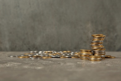 Photo of Many coins on table against color background, space for text
