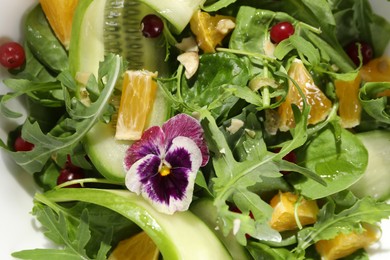 Photo of Delicious salad with cucumber and orange slices, closeup