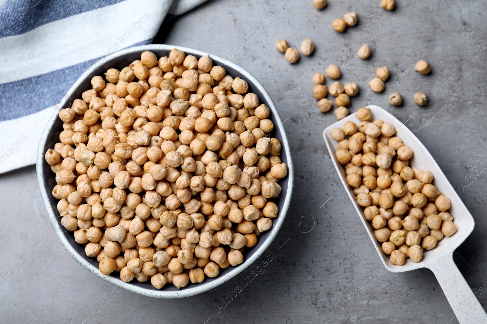 Photo of Raw chickpeas on grey table, flat lay