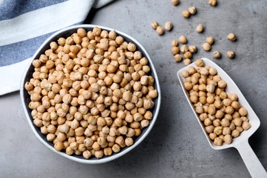 Photo of Raw chickpeas on grey table, flat lay