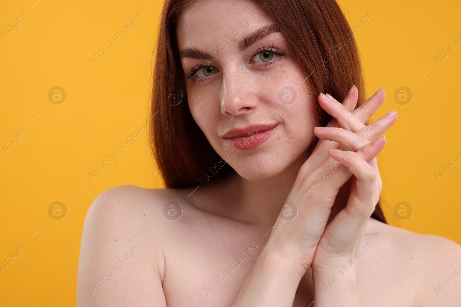 Photo of Portrait of beautiful woman with freckles on yellow background, closeup