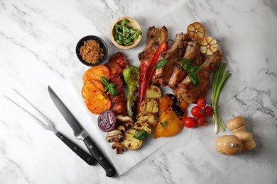 Delicious grilled meat and vegetables served on white marble table, flat lay