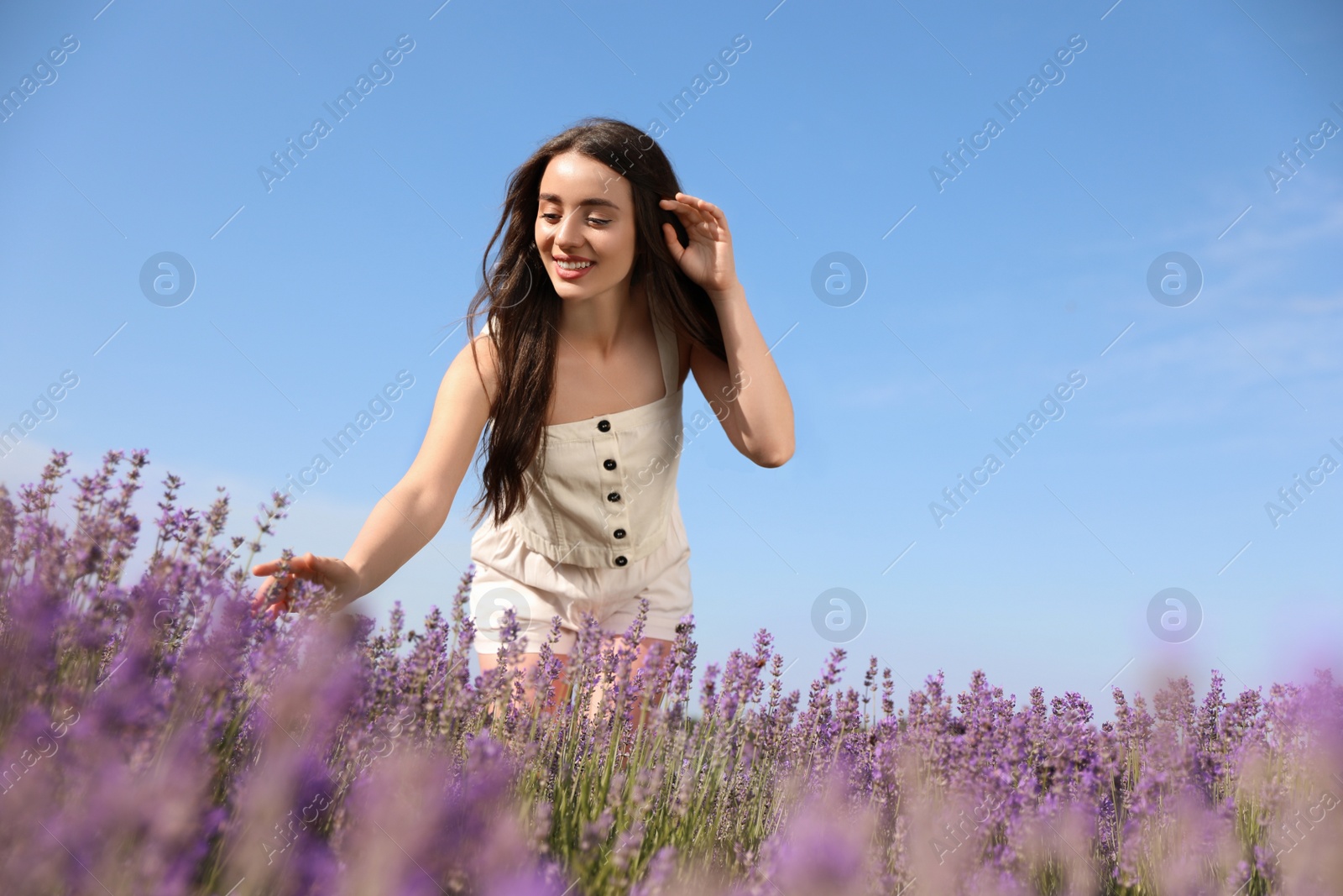 Photo of Young woman in lavender field on summer day