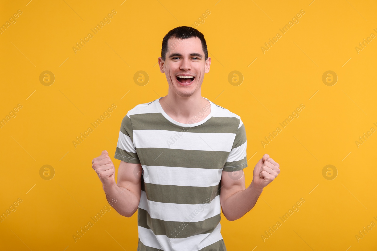 Photo of Portrait of surprised man on orange background