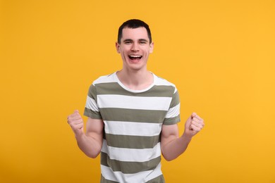 Photo of Portrait of surprised man on orange background