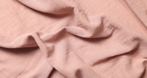 Photo of Texture of soft pastel crumpled fabric as background, top view