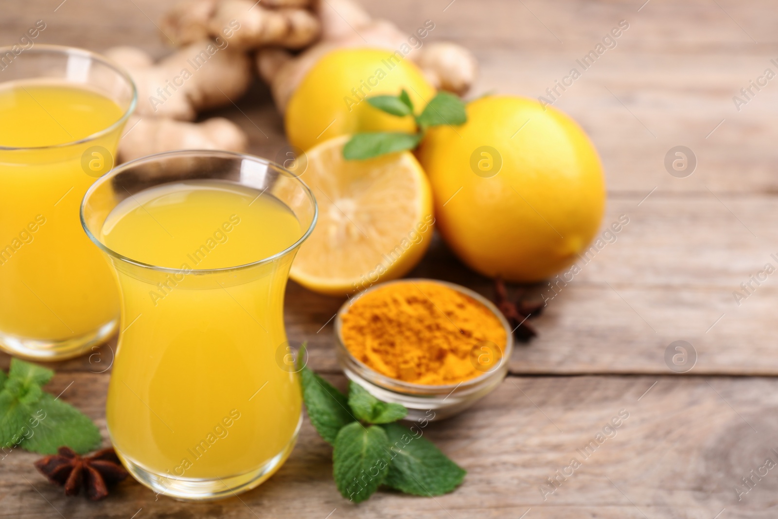 Photo of Immunity boosting drink and ingredients on wooden table. Space for text