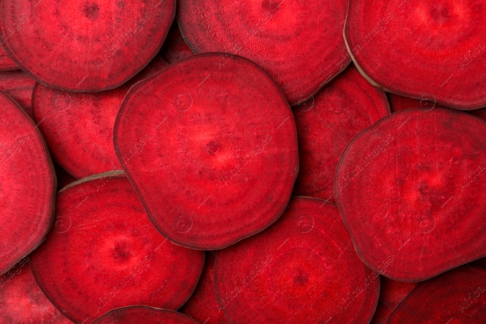 Photo of Slices of fresh beets as background, top view