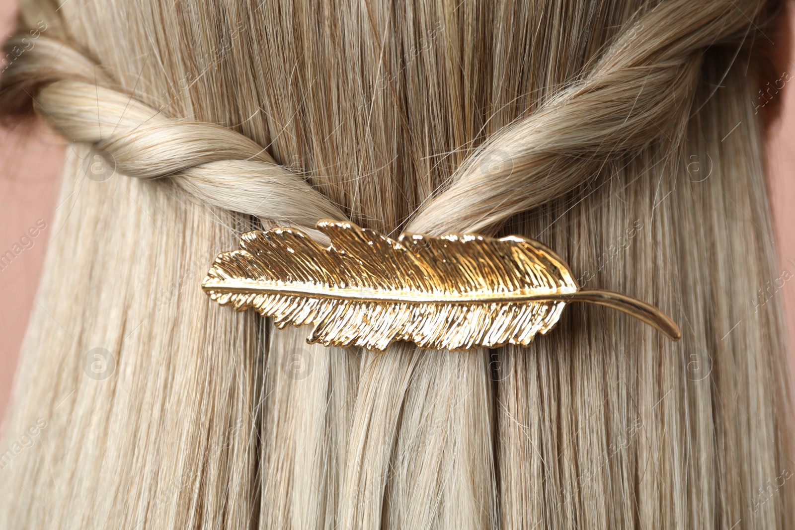 Photo of Woman with beautiful gold hair clip, closeup