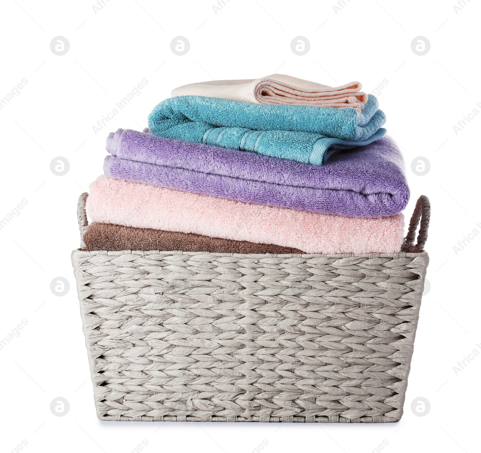 Photo of Wicker laundry basket with clean towels on white background