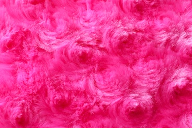 Photo of Texture of fuzzy pink fabric as background, closeup