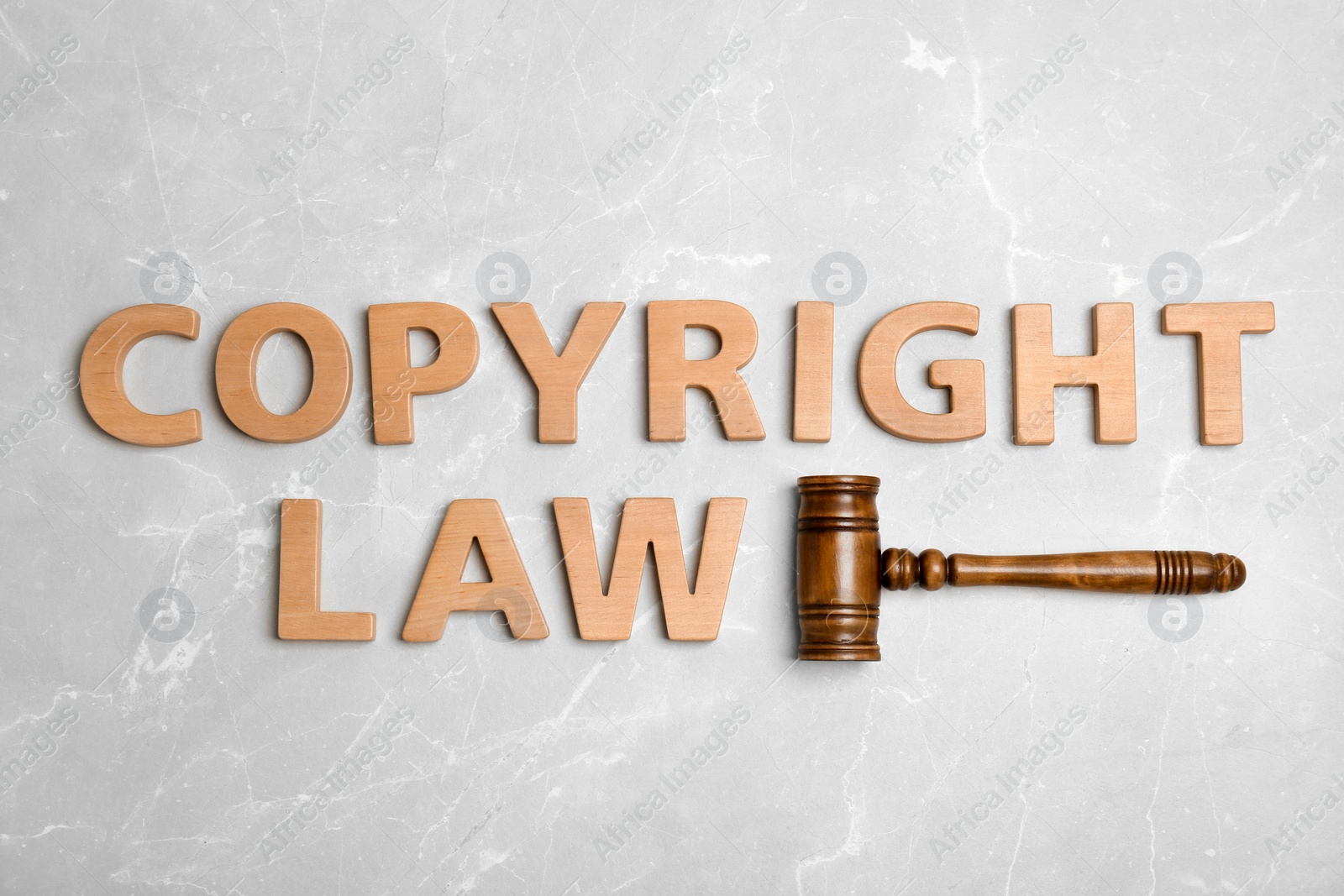 Photo of Flat lay composition with words COPYRIGHT LAW and gavel on grey background