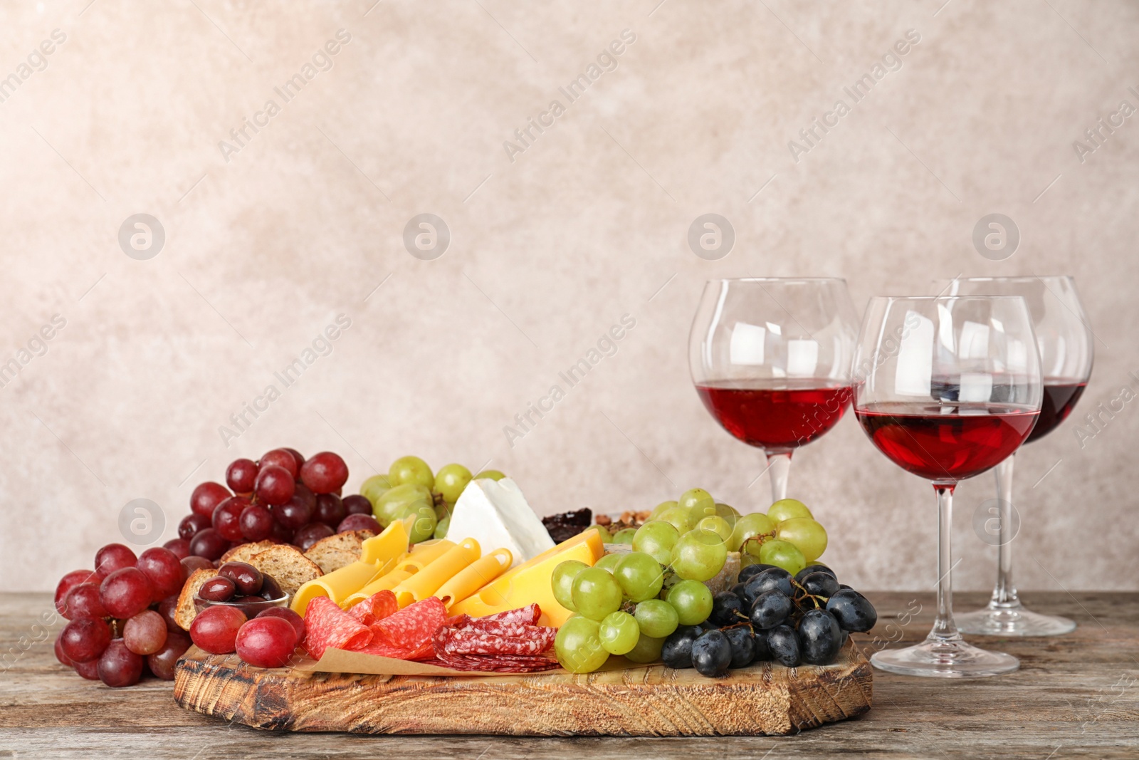 Photo of Composition with wine and snacks on wooden table