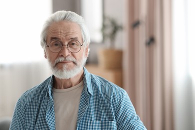 Portrait of happy grandpa with glasses indoors