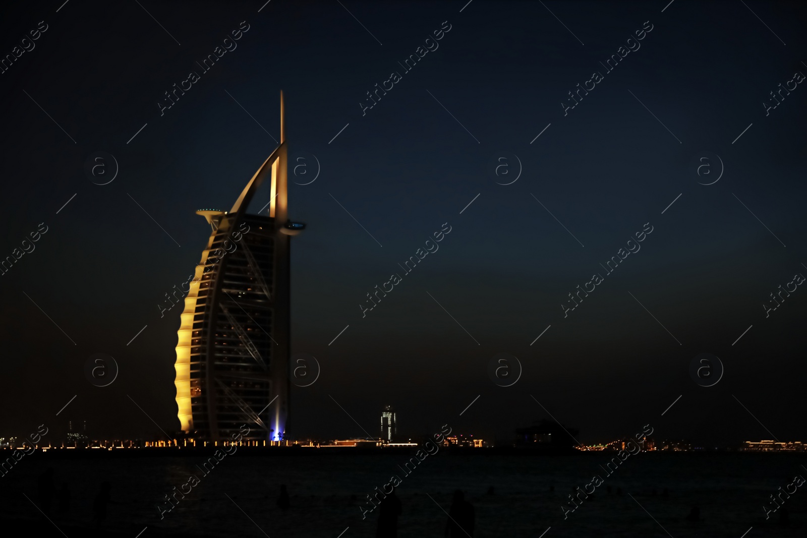 Photo of DUBAI, UNITED ARAB EMIRATES - NOVEMBER 03, 2018: Night landscape with illuminated Burj Al Arab