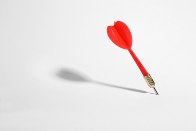 Photo of Red dart arrow for game on white background