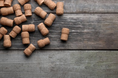 Sparkling wine bottle corks on wooden table, flat lay. Space for text