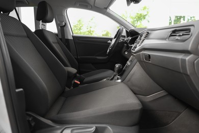 Photo of Stylish car interior with steering wheel and comfortable seats inside