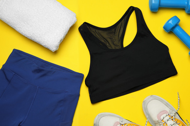Photo of Flat lay composition with stylish sportswear on yellow background