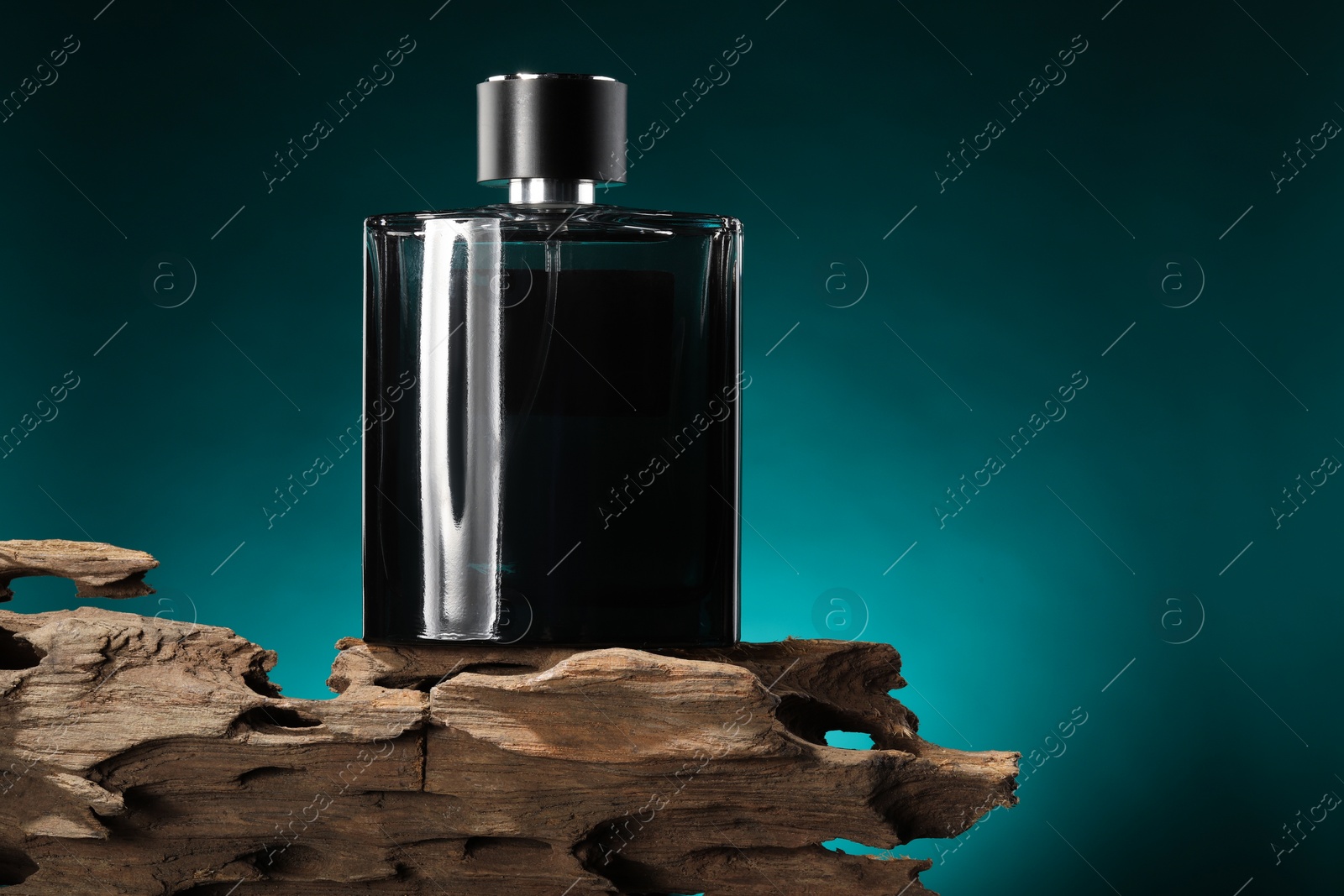 Photo of Luxury men`s perfume in bottle against color background, space for text