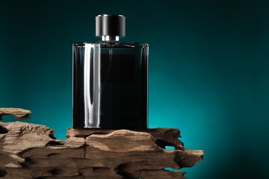 Luxury men`s perfume in bottle against color background, space for text