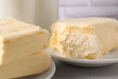 Photo of Tasty homemade butter and dairy products on white textured table, closeup
