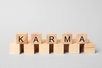 Word Karma made of cubes with letters on light background