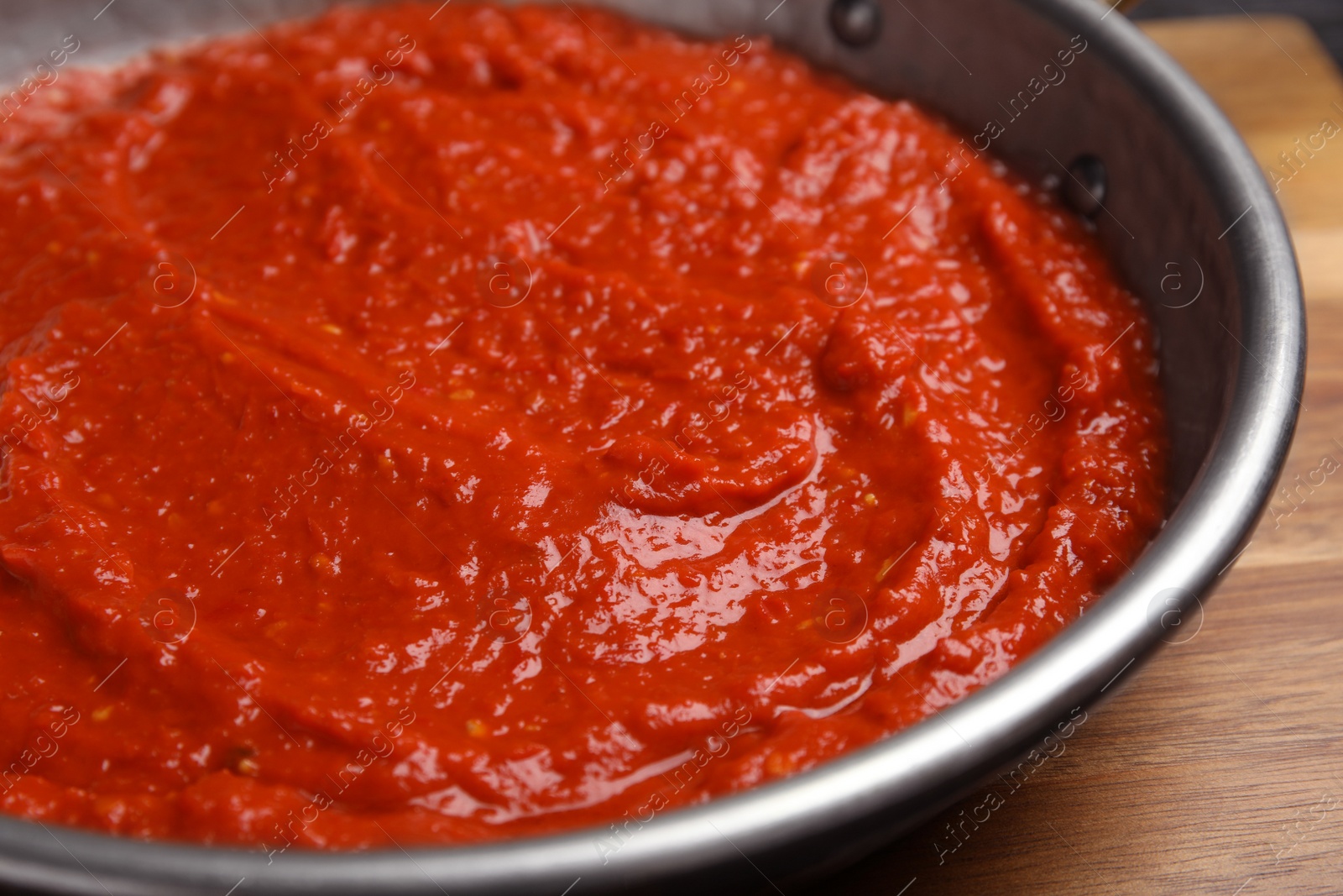 Photo of Delicious tomato sauce in pan, closeup view