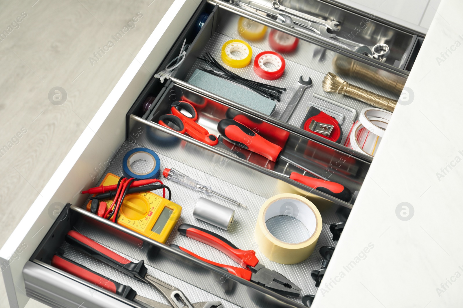 Photo of Set of instruments in open desk drawer indoors