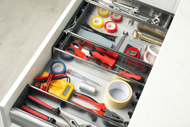 Photo of Set of instruments in open desk drawer indoors