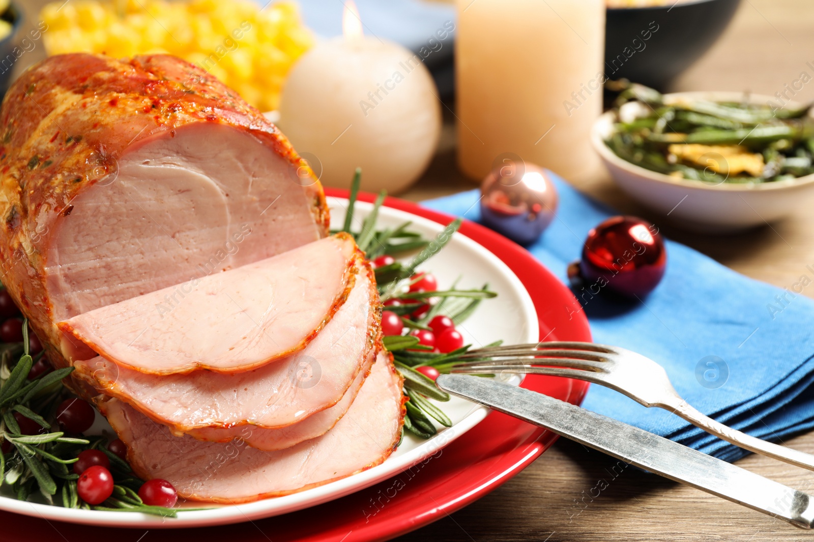 Photo of Delicious Christmas ham served with garnish on wooden table