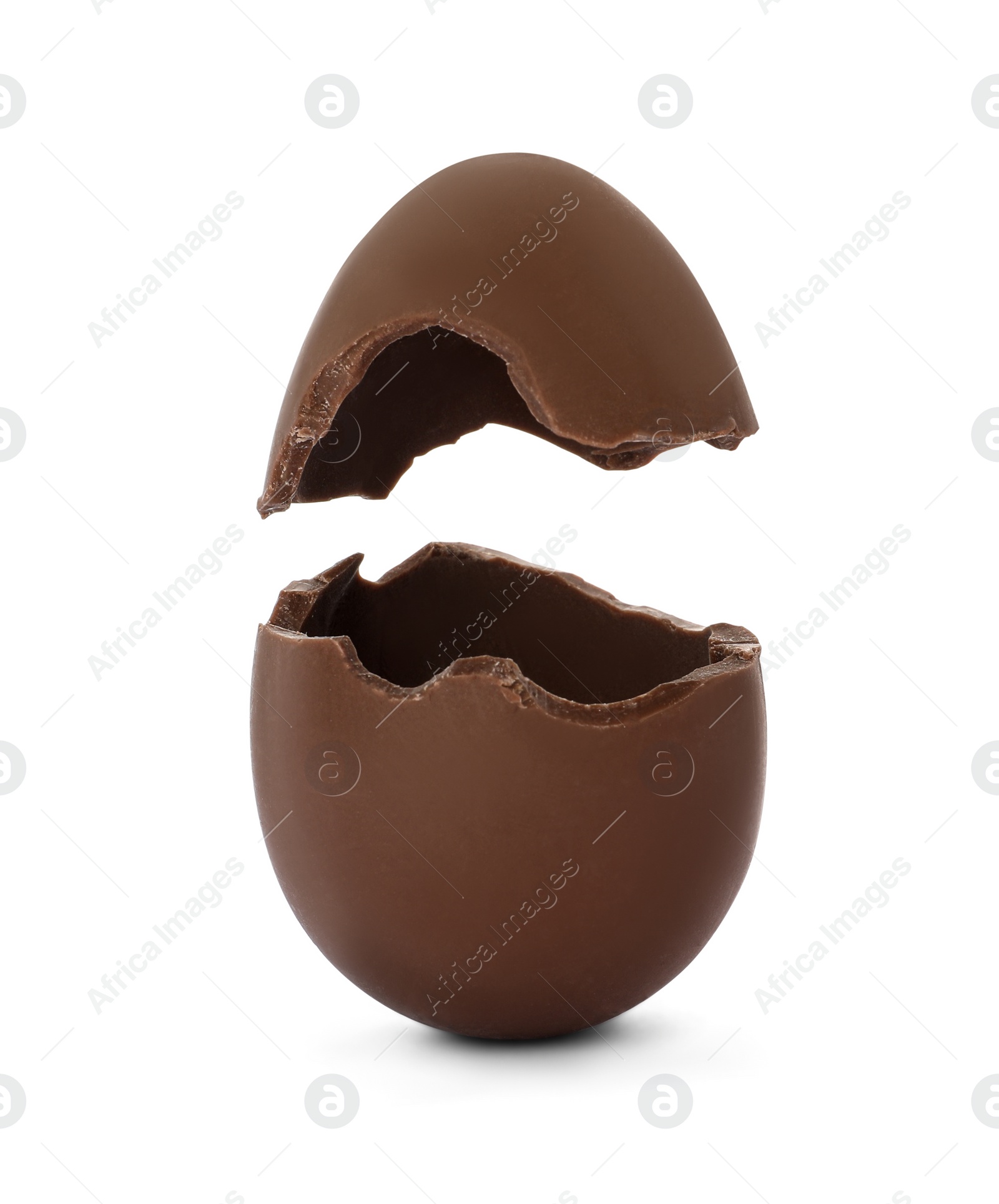 Image of Broken milk chocolate egg on white background