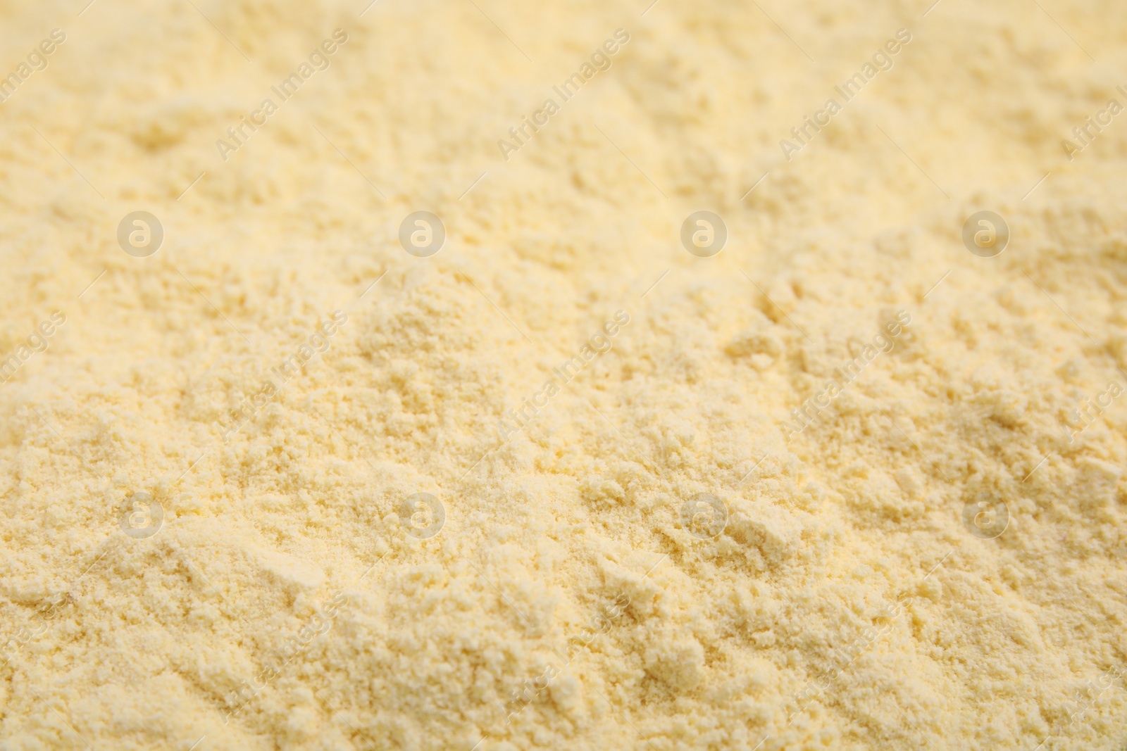 Photo of Pile of corn flour as background, closeup