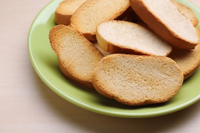 Plate of hard chuck crackers on wooden table, closeup