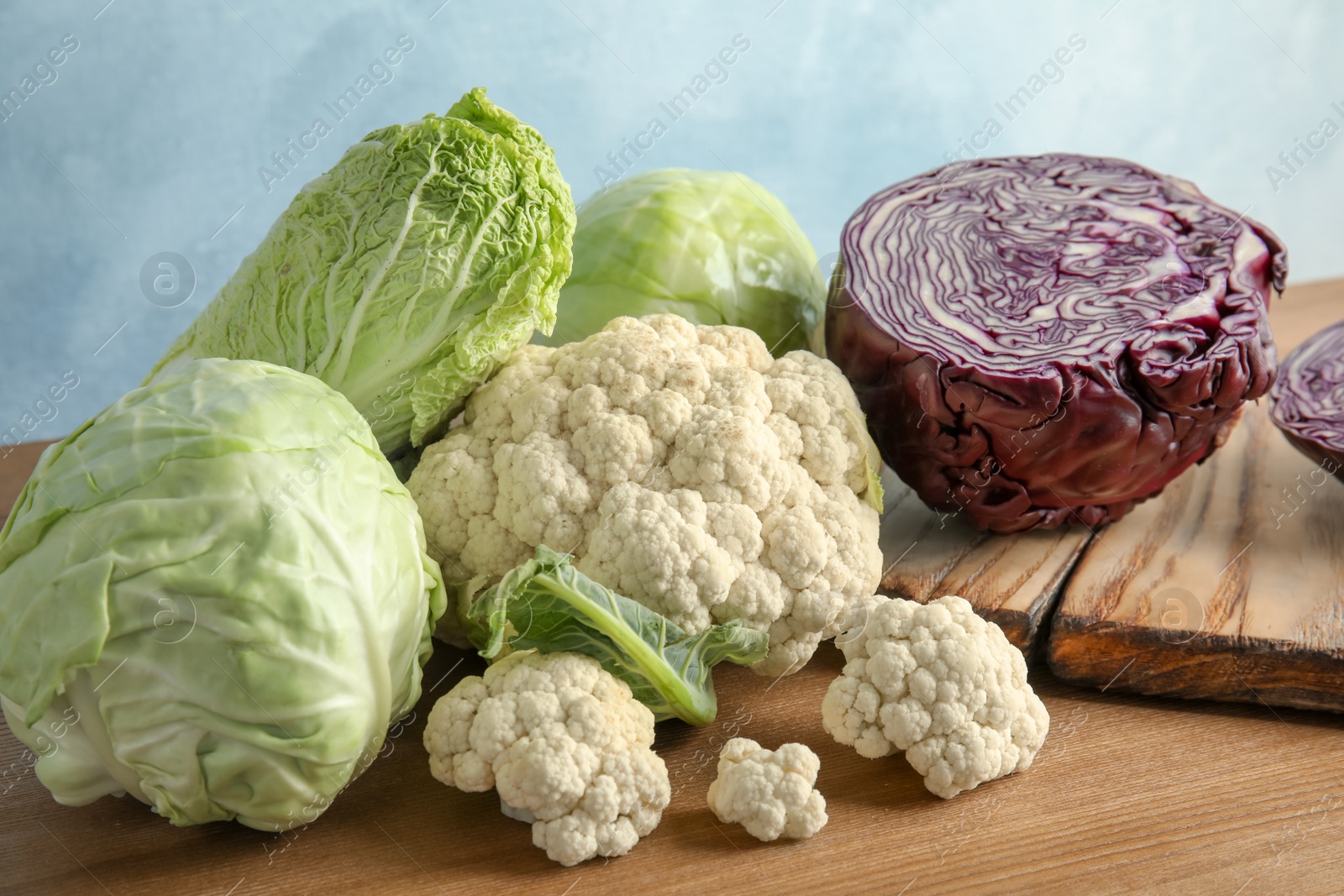 Photo of Different sorts of cabbage on wooden table