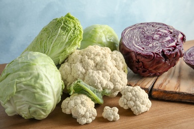 Different sorts of cabbage on wooden table