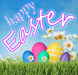 Image of Happy Easter. Bright eggs and spring flowers on green grass outdoors