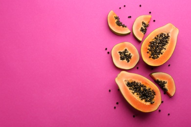 Photo of Fresh ripe papaya fruits on purple background, flat lay. Space for text