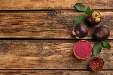 Photo of Purple mangosteen powder and fruits on wooden table, flat lay. Space for text