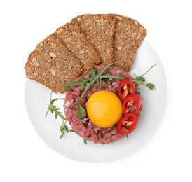 Tasty beef steak tartare served with yolk, pepper, bread and greens isolated on white, top view