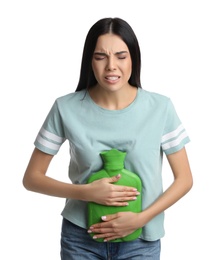Photo of Woman using hot water bottle to relieve abdominal pain on white background