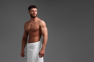 Photo of Handsome muscular man on grey background, space for text. Sexy body