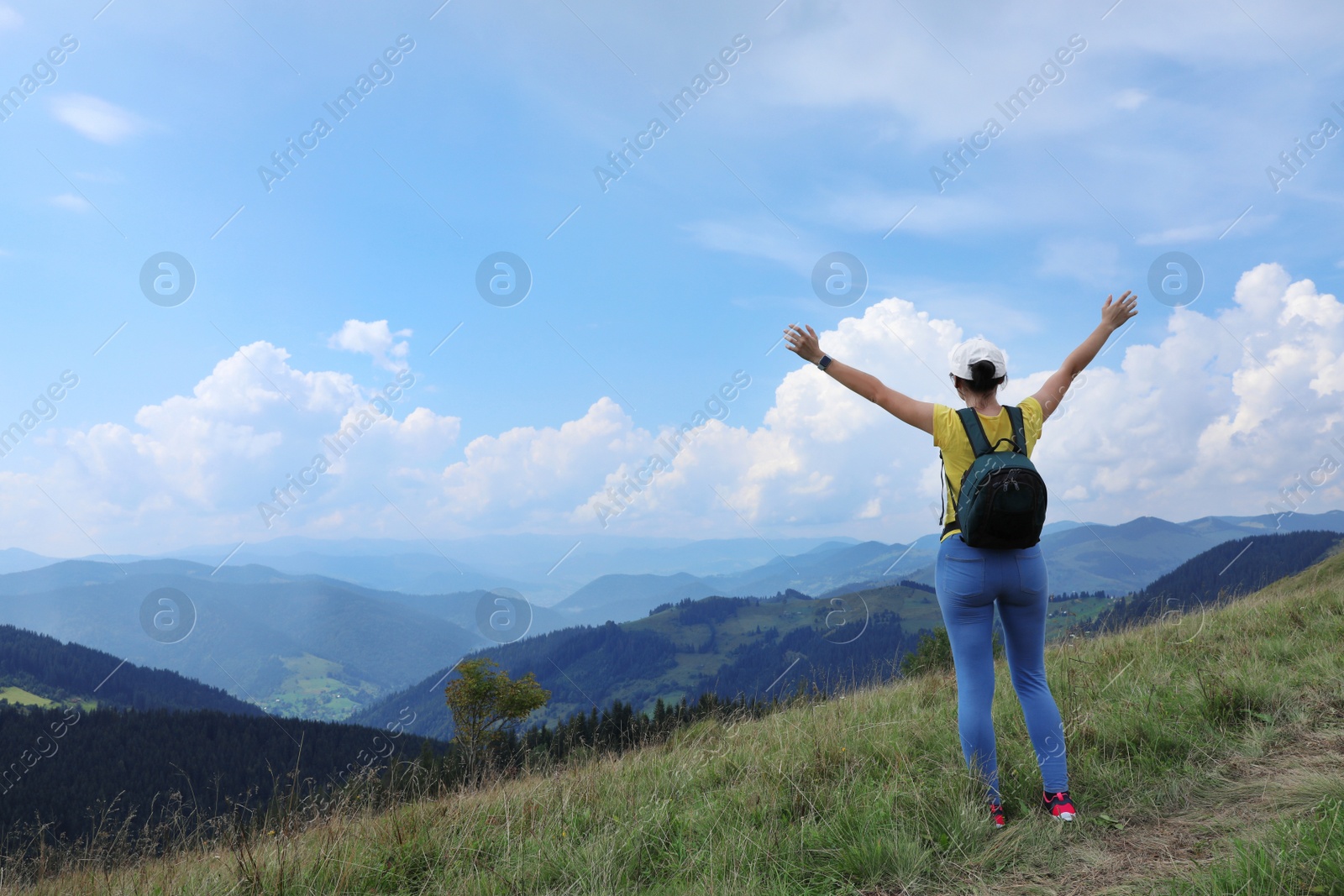 Photo of Woman with backpack in wilderness. Mountain landscape