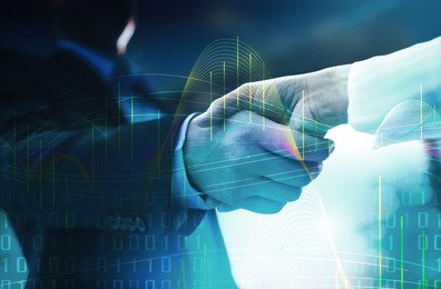 Deal or partnership concept. Double exposure with charts, binary code and photo of businesspeople shaking hands, toned in blue